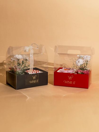 Our "Blossom & Bites" hamper is the perfect pick-me-up. It combines fresh, beautiful flowers with a delicious bento cake in a stylish, transparent box, making it a sweet and simple gesture of care.