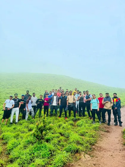 Our group standing together on a vast green meadow during the Bandaje trek, with the fog creating a mysterious atmosphere.
