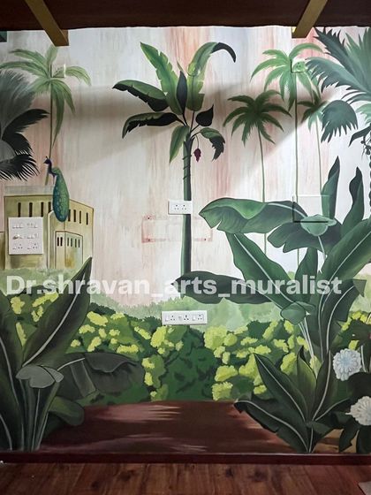 This mural for a photo studio in Pondicherry brings a lush, tropical vibe with banana trees and a peacock, creating a perfect backdrop.