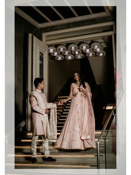 A beautifully composed shot of the couple on a grand staircase, exuding elegance and romance during their engagement shoot.