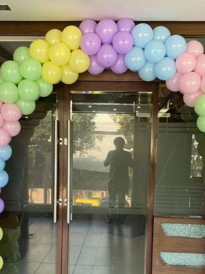 A simple and beautiful pastel rainbow balloon arch, perfect for a welcoming entrance for a baby shower or welcome home party.