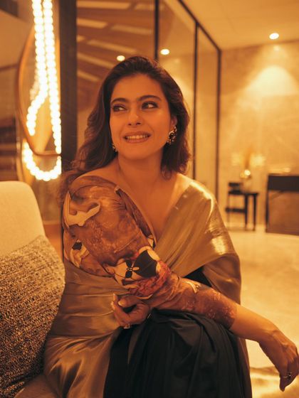 A candid, smiling shot that shows the comfortable elegance of the saree in a relaxed setting.