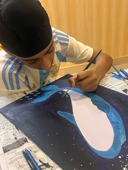 Deep in concentration, this young artist is carefully painting the details on his deep-sea whale canvas. My one-on-one sessions provide the focused guidance needed to tackle more complex projects and refine painting skills.