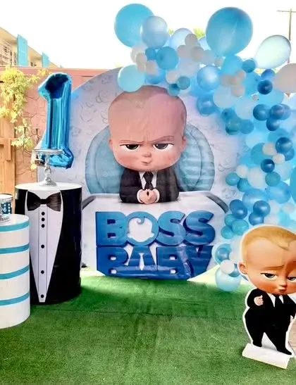 A fun Boss Baby theme with a large character backdrop and props designed to look like a tuxedo.