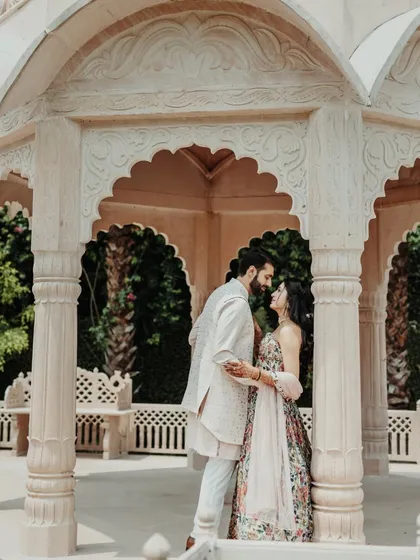 A romantic portrait of the couple inside a beautiful white gazebo, a perfect setting for their love story.
