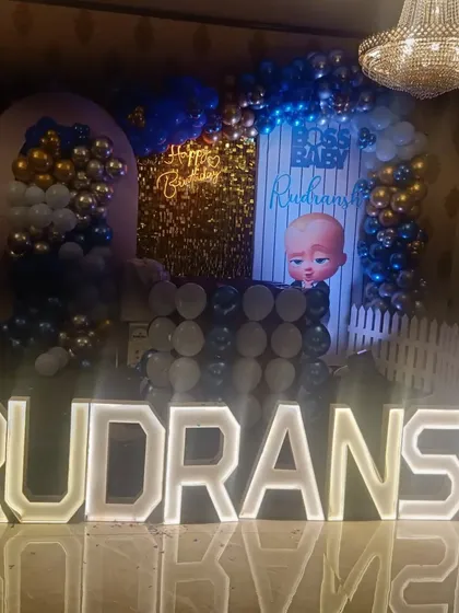 This photo captures the full Boss Baby themed stage decoration, ready for the celebration to begin.