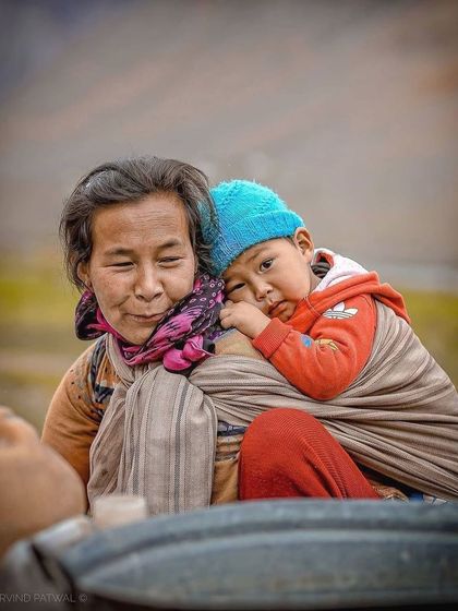 A beautiful portrait capturing the love between a mother and her child in Spiti Valley. It's a universal moment of tenderness set against the backdrop of the Himalayas.