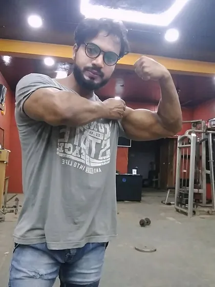 Checking the results of consistent hard work. Building strong arms requires dedication and the right set of exercises.