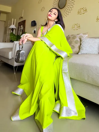 Another angle of the neon saree look. The silver clutch and earrings are the perfect cool-toned accessories to balance the bright, warm neon.