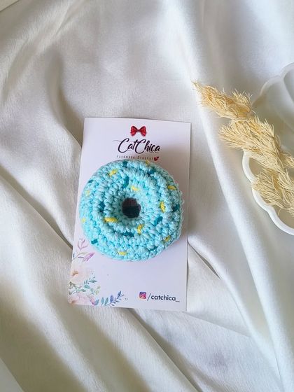 A close-up of our blue frosted donut clip. The little yellow sprinkles are all hand-stitched.