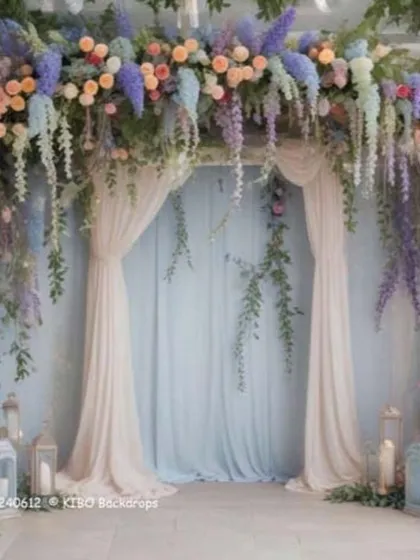I can bring fairytale wedding themes to life. This backdrop uses a mix of pastel flowers like roses and wisteria with hanging greenery to create an enchanting, garden-like setting.
