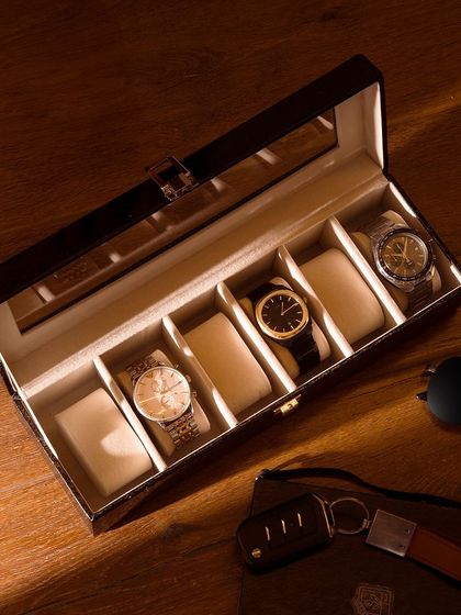 A luxury watch box styled in a warm, sophisticated setting with car keys and sunglasses. This shot tells the story of a refined lifestyle.