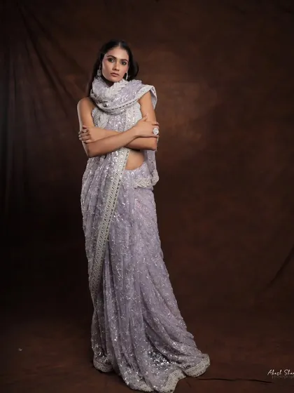 A full-length shot of the lavender lehenga, with the dupatta wrapped for a chic, modern look. This shows the versatility of the traditional garment.