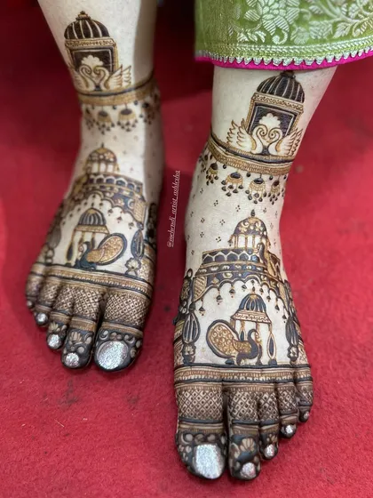 A close-up of the royal bridal feet design. This image highlights the detailed work on the palanquins, peacocks, and swans.