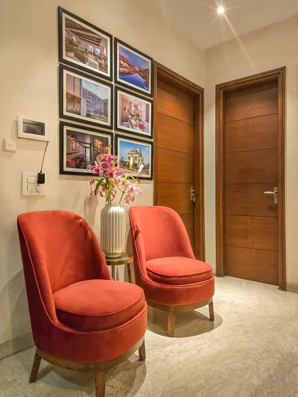 A welcoming waiting area sets the tone for an entire office. Here, plush, rust-colored chairs create an inviting nook for visitors, complemented by a gallery wall showcasing our past architectural projects.
