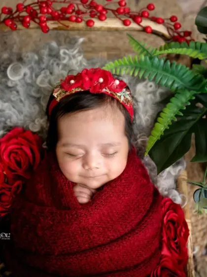 This little beauty is surrounded by red roses, looking so serene in a matching wrap and headband. I love incorporating floral elements to add color and softness to my newborn photography.