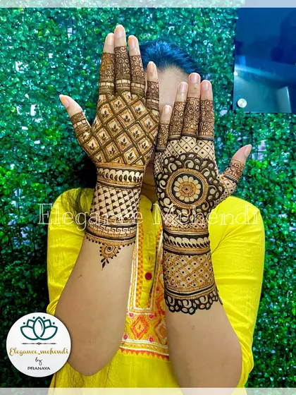 A different style of backhand mehendi, with a large mandala on one hand and a geometric grid pattern on the other.