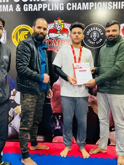 Awarding a certificate and medal to a student at our Inter club MMA & Grappling Championship. These events are crucial for building a strong foundation for future champions.