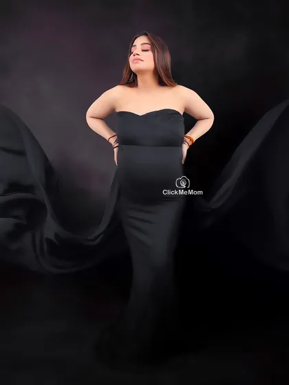 The beauty of movement. Using flowing black fabric, I create a sense of drama and artistry around the expectant mother, turning a simple pose into a dynamic and captivating maternity portrait.