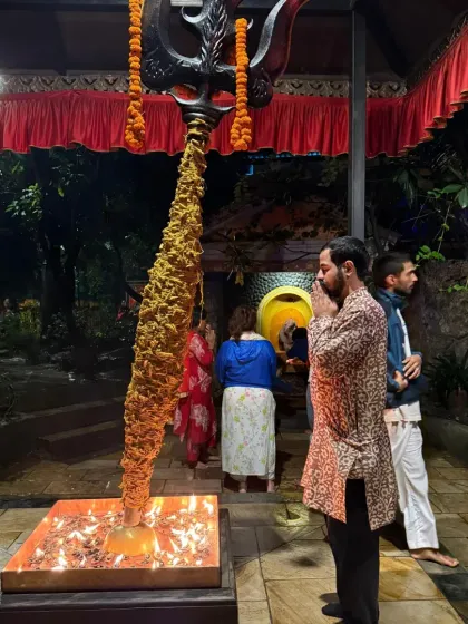 Offering my prayers before the Trishul and lamp stand at the Linga Bhairavi temple. The Devi's presence is palpable and intensely feminine.