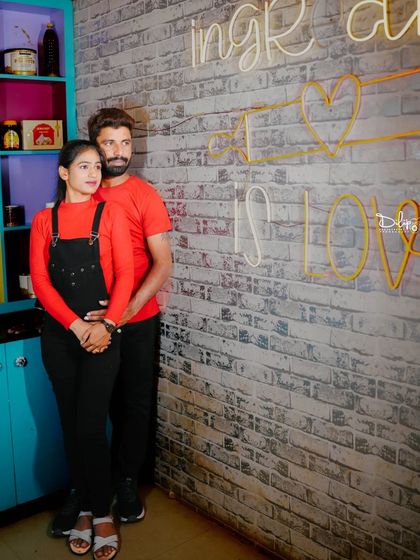 A classic portrait in the kitchen set, with the neon sign in the background.