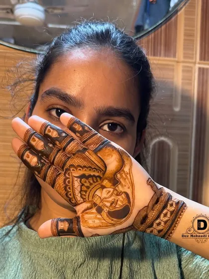 The same client showing her face, confident in the beautiful portrait mehndi she received as a free trial.