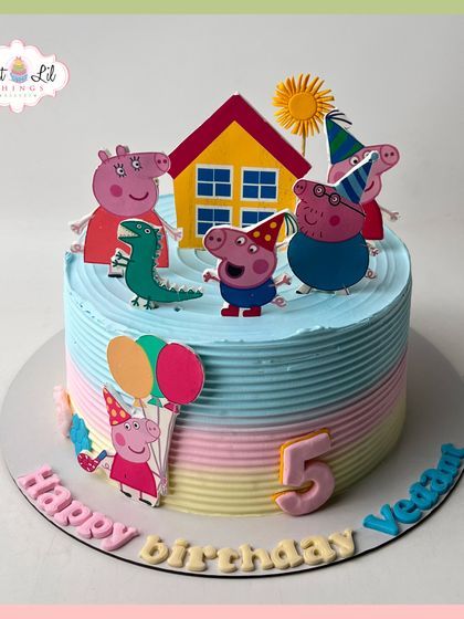 A fun-filled Peppa Pig party on a cake. This colorful creation for a 5th birthday features Peppa, George, and their family enjoying a sunny day.