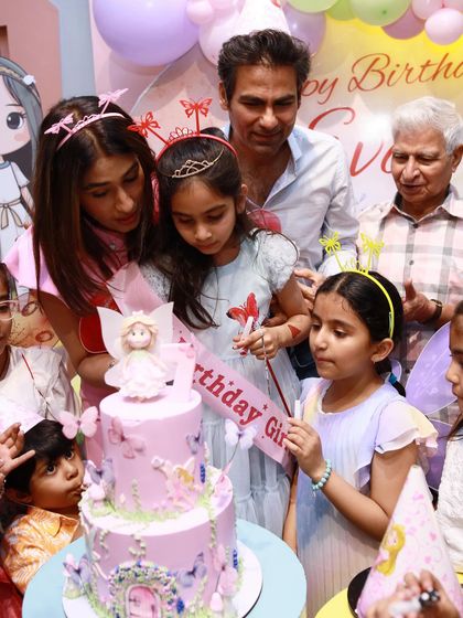 The Kaif family gathers for the cake-cutting ceremony. The butterfly-themed cake is the perfect centerpiece for their daughter's magical party.