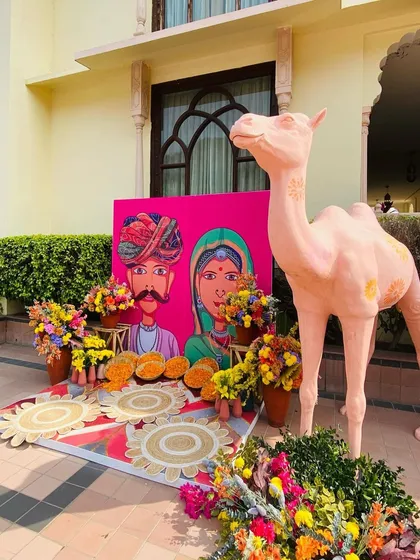 For a Rajasthani-themed Mehendi, I created this fun and colorful photo booth. It features a quirky hand-painted backdrop, a life-sized camel prop, and an abundance of multi-colored flowers, offering guests a perfect spot for festive pictures.