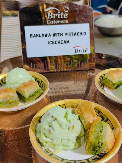 A close-up of the delightful pairing of sweet, nutty baklava and refreshing pistachio ice cream.