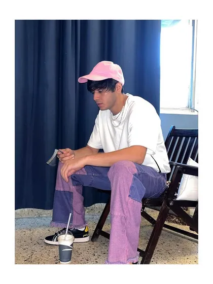 A candid shot of Anshuman Malhotra in the pink and purple outfit I styled. This look shows my approach to men's fashion, using bold colors and contemporary pieces to create memorable outfits.