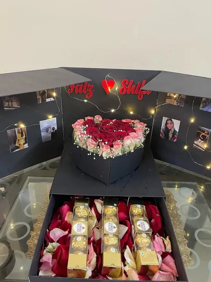 This angle highlights the depth of the box, showing the rich bed of red and pink rose petals in the bottom drawer where the Ferrero Rocher chocolates are placed. Every detail is designed to create a memorable experience.