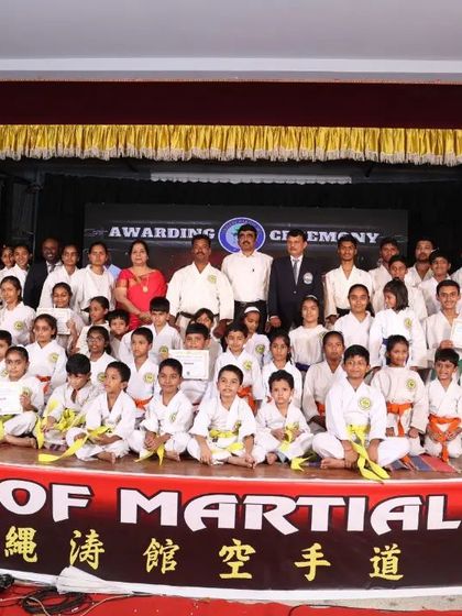 A group photograph from our 2023 Black Belt Awarding Ceremony. Students of all ages and belt levels come together to celebrate the achievements of our new Kuro Obi holders.