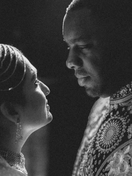 A powerful black and white close-up, capturing the intense and loving gaze between the couple during their Sangeet.