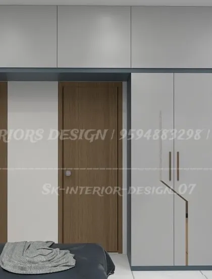 A dual-tone wardrobe design in white and blue with sleek, modern handles. The loft storage above provides extra space, making it ideal for compact bedrooms.
