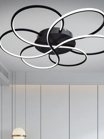 This modern floret chandelier has a unique flower-like design made of interlocking rings. It's a flush-mount fixture, making it suitable for rooms with standard ceiling heights. It provides bright, even light for a living room or bedroom.
