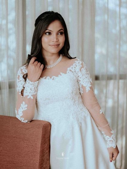 A beautiful portrait of the bride in her white lace gown, looking elegant and serene.