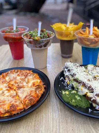 A complete meal at Mumbai Bites includes Freyo Towers, pizza, and sandwiches. It's a feast for everyone.