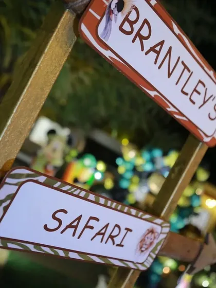 A close-up of the custom-made safari party directional sign. The animal-print border and fun font are part of the detailed personalization I offer for every event.
