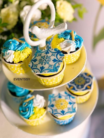 Beautifully decorated cupcakes with edible toppers featuring the classic blue and white patterns.