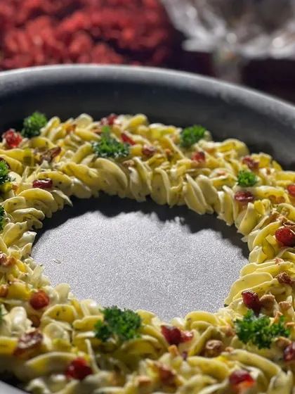 Our Christmas-themed butter board, piped into a beautiful wreath shape and garnished with fresh herbs and dried fruit.