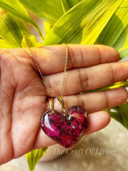 A perfect Valentine's Day gift idea. This heart-shaped pendant is filled with real preserved rose petals, symbolizing love that lasts forever. It's a beautiful and meaningful piece of jewelry.