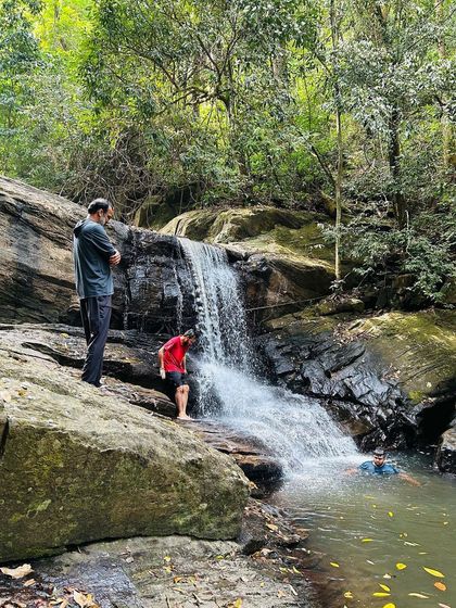 A refreshing dip in a hidden waterfall is part of our Kumara Parvatha circuit trek experience.
