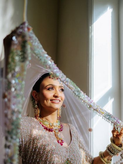 The sun catching Tithi's smile through her veil. Her glowing skin looks absolutely luminous.