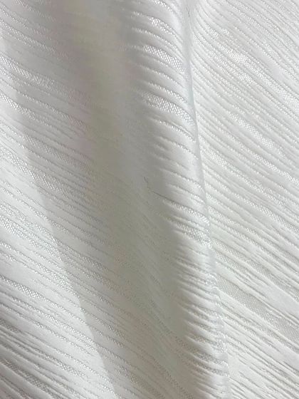 This is the imported white textured fabric used for the award-night blazer. Its unique weave adds depth and a luxurious feel to the garment.
