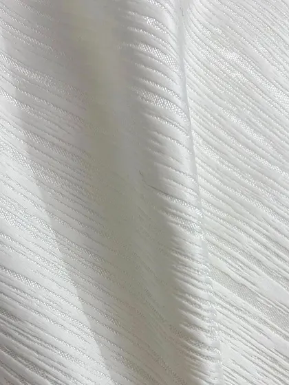 This is the imported white textured fabric used for the award-night blazer. Its unique weave adds depth and a luxurious feel to the garment.