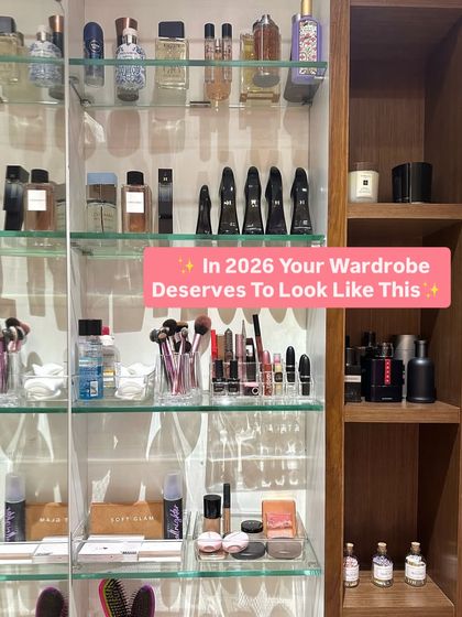 We utilize vertical space in a vanity cabinet with glass shelves and clear organizers. This system is perfect for storing perfumes, makeup brushes, and skincare products.