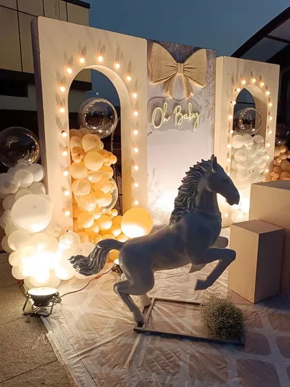 Another angle of the elegant horse-themed baby shower. This view shows the full setup with pedestals for cake or gifts, highlighting the beautiful symmetry and thoughtful design of the entire backdrop.