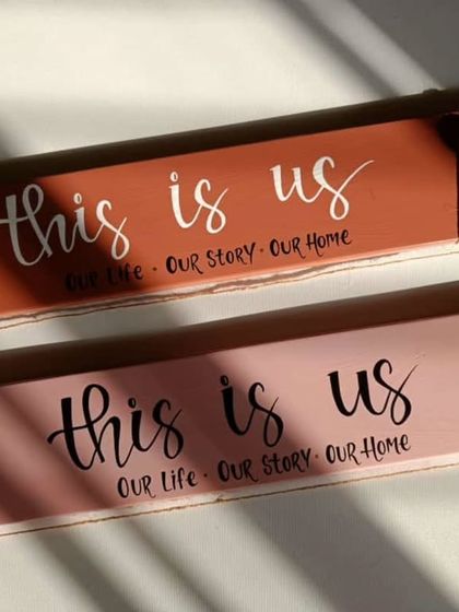 The "this is us" photo clippers, bathed in sunlight. The hand-painted lettering and rustic jute details create a warm, inviting feel.