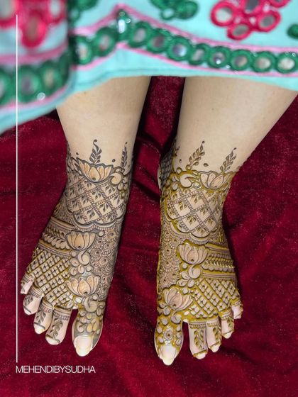 The same lotus foot design peeking out from under the bride's lehenga.
